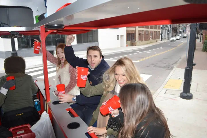 a group of people sitting at a bus stop