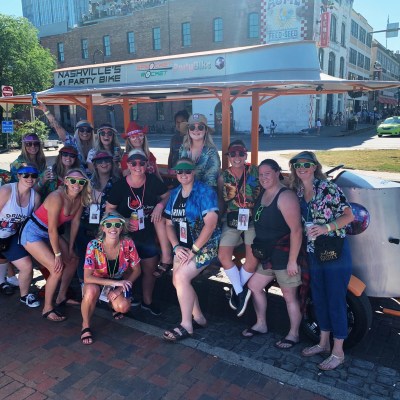 a group of people standing in front of a crowd posing for the camera