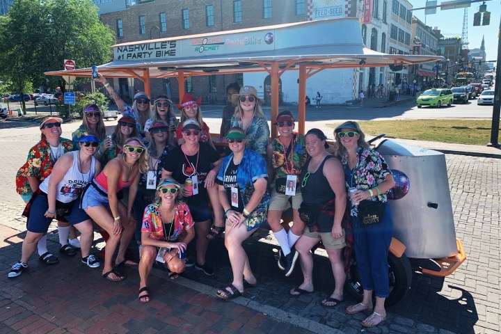 a group of people standing in front of a crowd posing for the camera