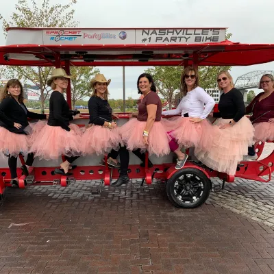 a group of people sitting on a motorcycle