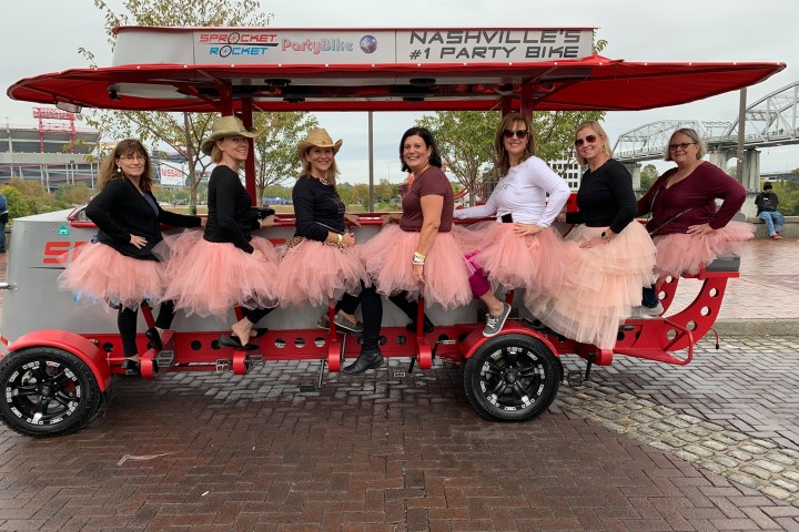a group of people sitting on a motorcycle