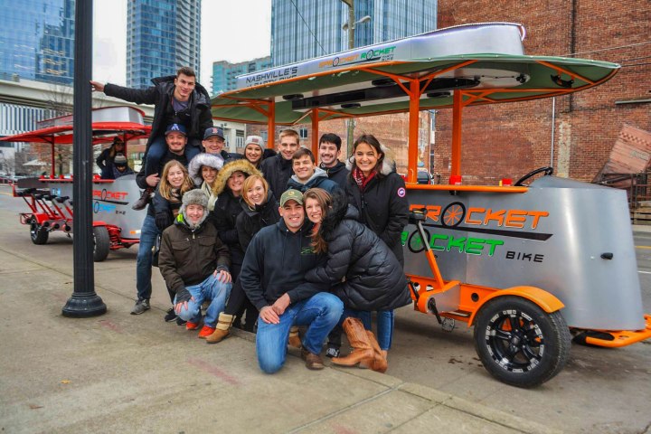 a group of people riding on the back of a truck